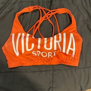 Victoria’s Secret sports bra. Size medium. The color is a mix between red&orange
